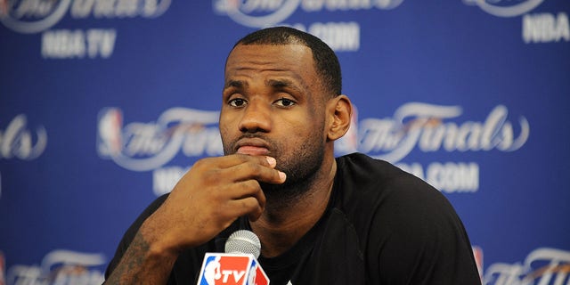 Miami Heat's LeBron James speaks to the media