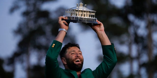 Jon Rahm holds the Masters trophy after winning at Augusta National Golf Club on Sunday, April 9, 2023.