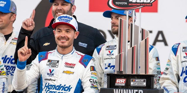 Kyle Larson stands next to his trophy after winning a NASCAR Cup Series auto race at Richmond Raceway, Sunday, April 2, 2023, in Richmond, Va. 