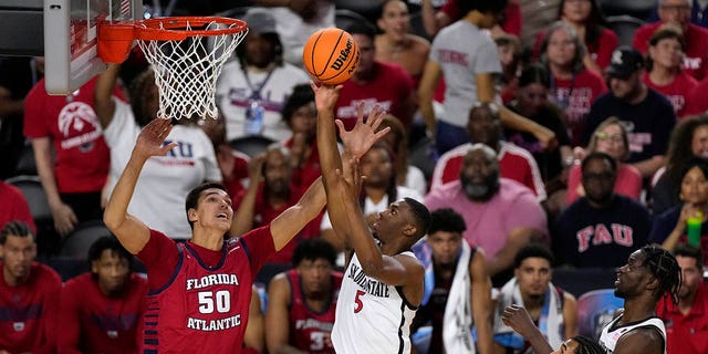 San Diego State guard Lamont Butler (5) shoots over Florida Atlantic center Vladislav Goldin (50) during the first half of a Final Four college basketball game in the NCAA Tournament on Saturday, April 1, 2023, in Houston.