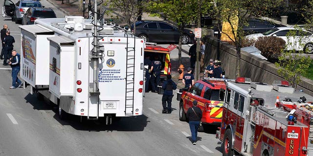 The Louisville metro Police Command Center along with units of the Louisville Fire Department are staged a block from the Old National Bank building in Louisville, Ky., Monday, April 10, 2023. 