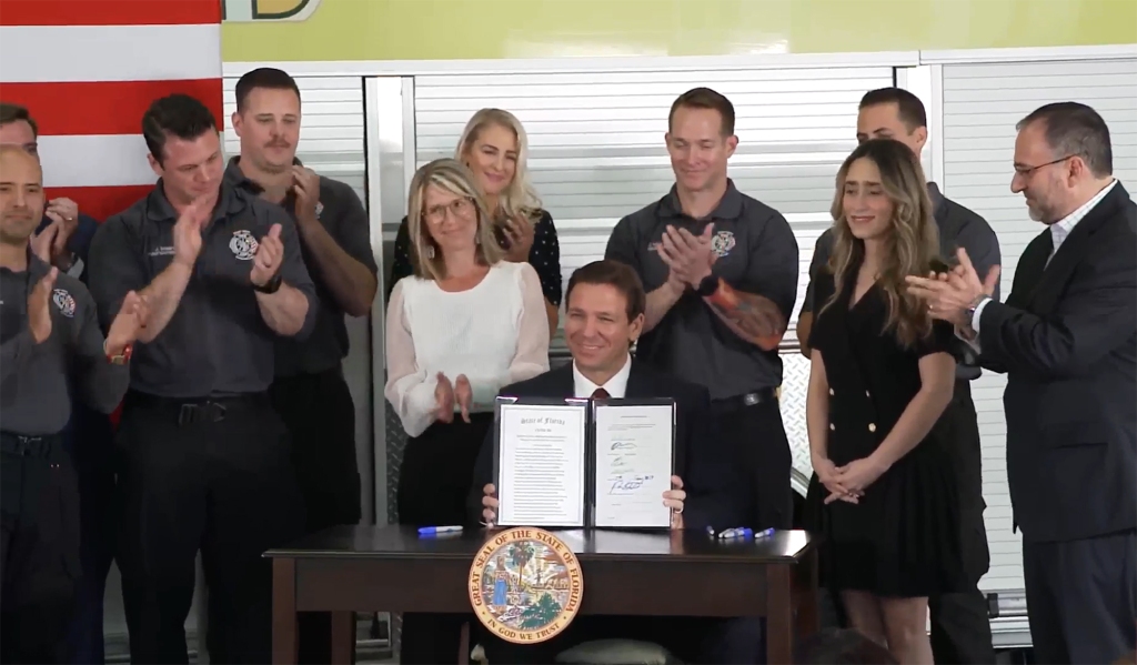 DeSantis signing legislation to end Disney's self-governing status on February 27, 2023.