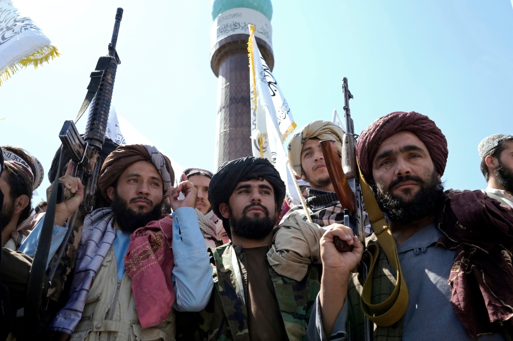 Taliban fighters celebrate the first anniversary of the withdrawal of US-led troops from Afghanistan, in front of the U.S. Embassy in Kabul, 