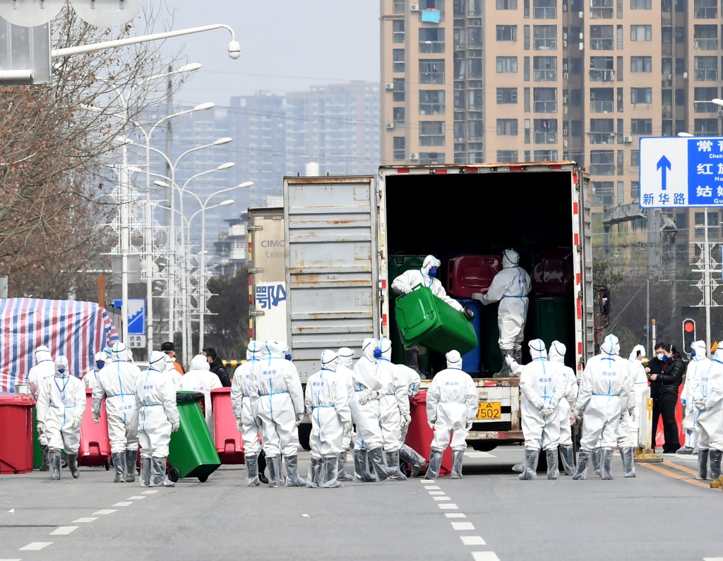 Workers in protective suits take part in the disinfection of Huanan seafood market.