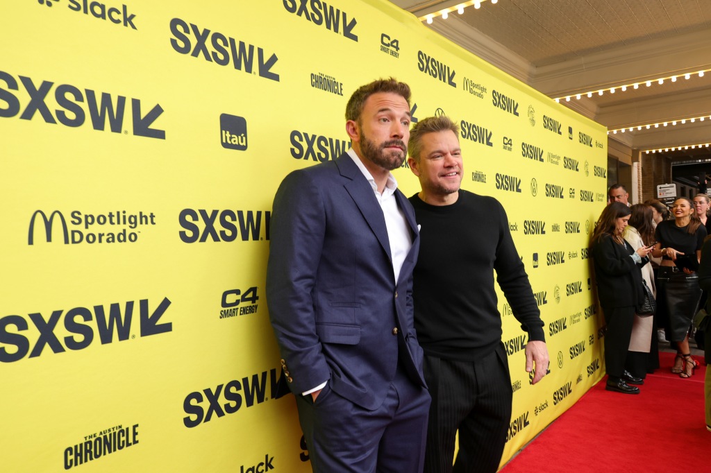 Ben Affleck and Matt Damon smiling on a red carpet. 