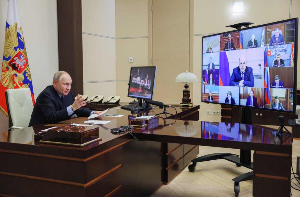 Vladimir Putin chairs a meeting with the government via a video link.