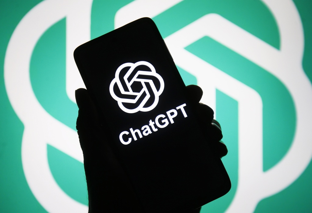 In this photo illustration, ChatGPT logo of a chatbot launched by OpenAI is seen on a smartphone in a hand.