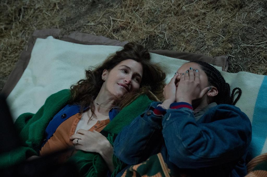 Clare (Kathryn Hahn) and Rae (Tanzyn Crawford) lay side by side in "Tiny Beautiful Things." 