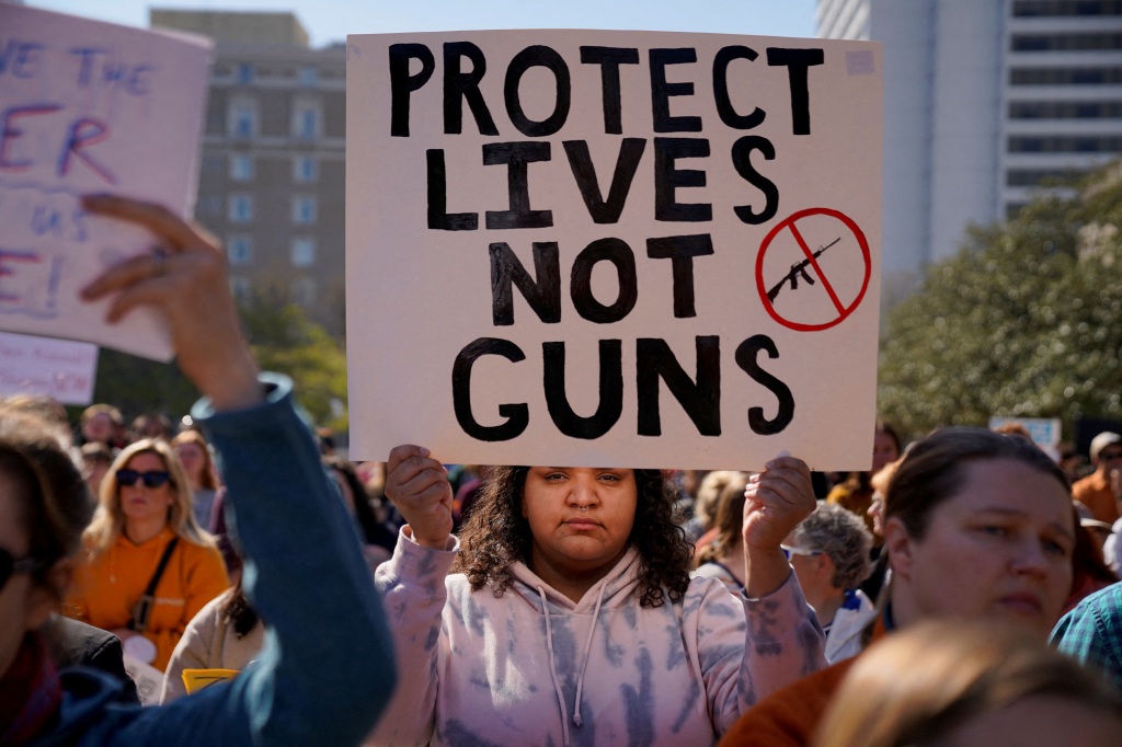 Student protester holds sign saying: "Protect lives not guns."