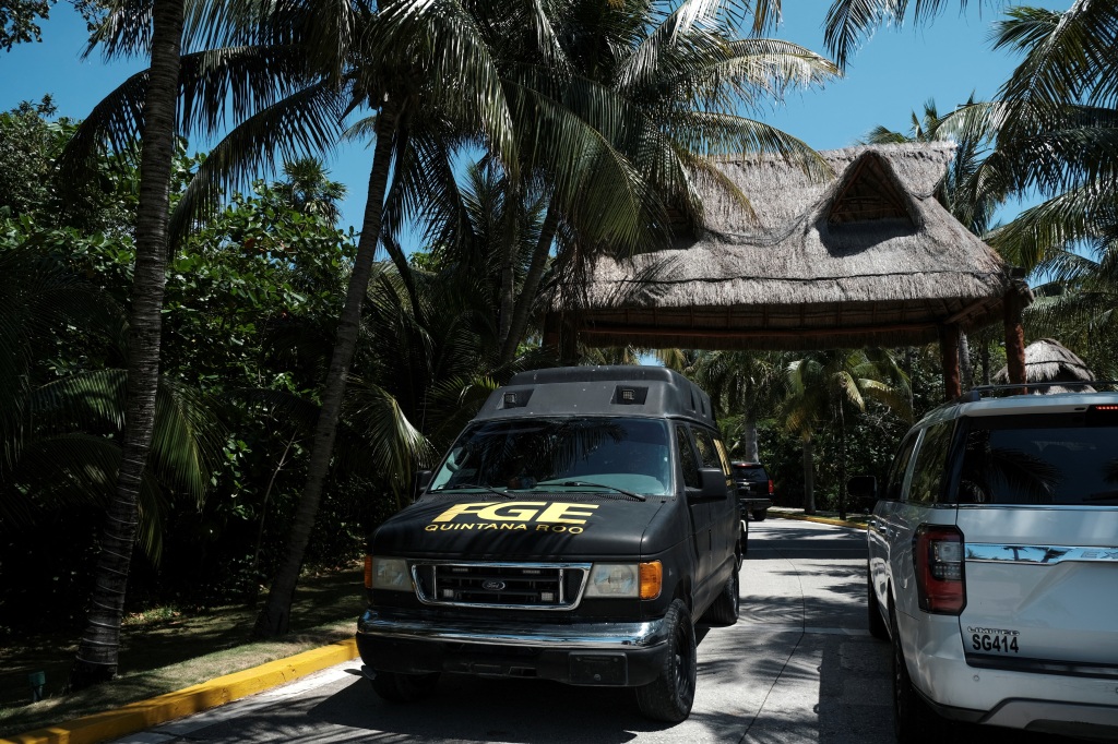 A vehicle of the attorney general's office leaves the Fiesta Americana hotel after people were gunned down near the beach