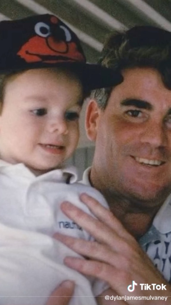 A very young Dylan Mulvaney and her father, James.