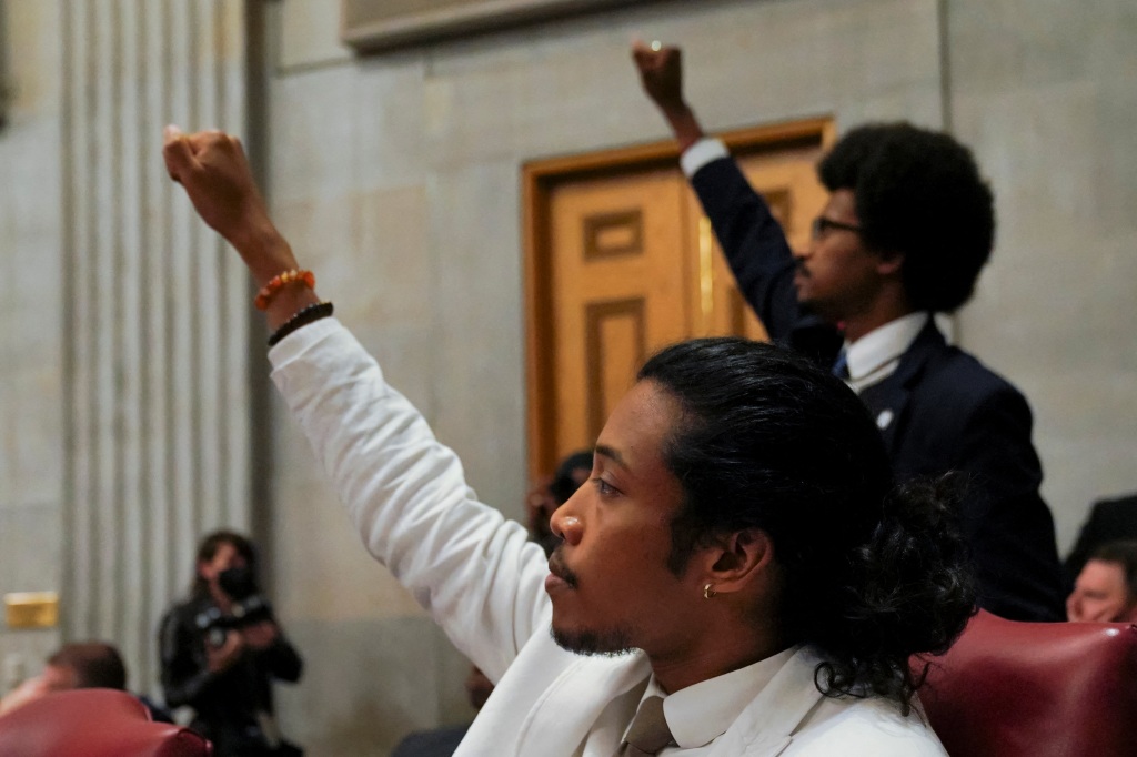Pearson and Jones raising their fists before getting expelled from the Tennessee House of Representatives.
