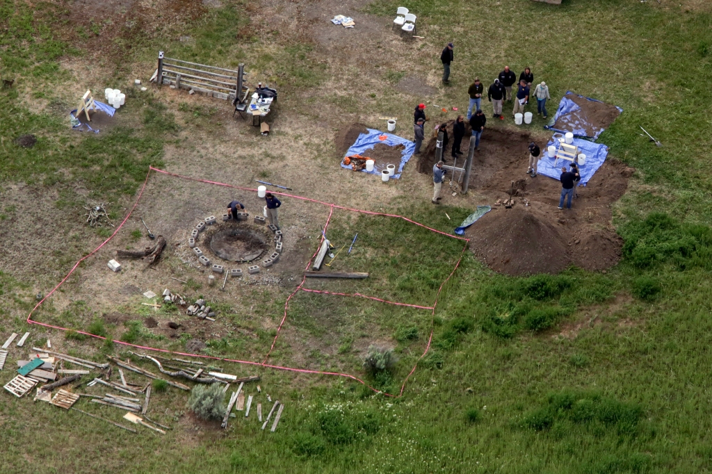 In this aerial photo, investigators search for human remains at Chad Daybell's residence in the 200 block of 1900 east, Tuesday, June 9, 2020, in Salem, Idaho. Authorities say they uncovered human remains at Daybell's home as they investigated the disappearance of his new wifeâs two children. 