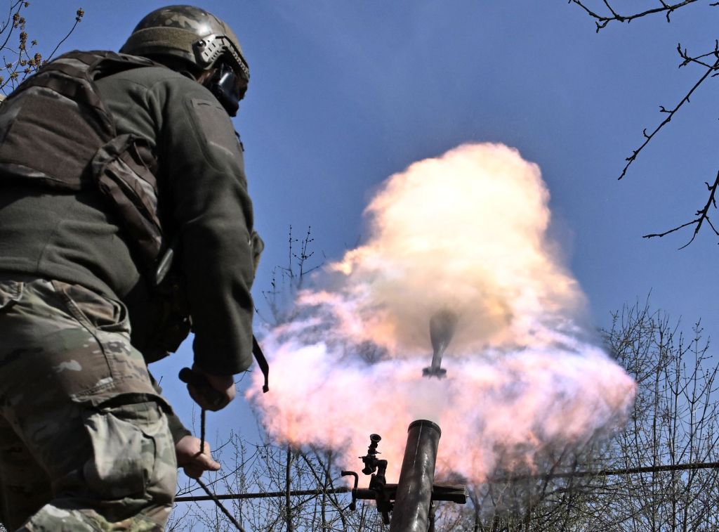 A Ukrainian soldier launches a mortar.