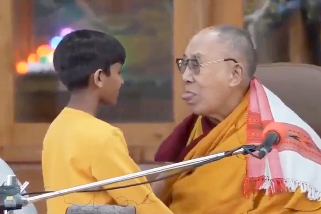 The Dalai Lama and the young boy in a questionable position. 