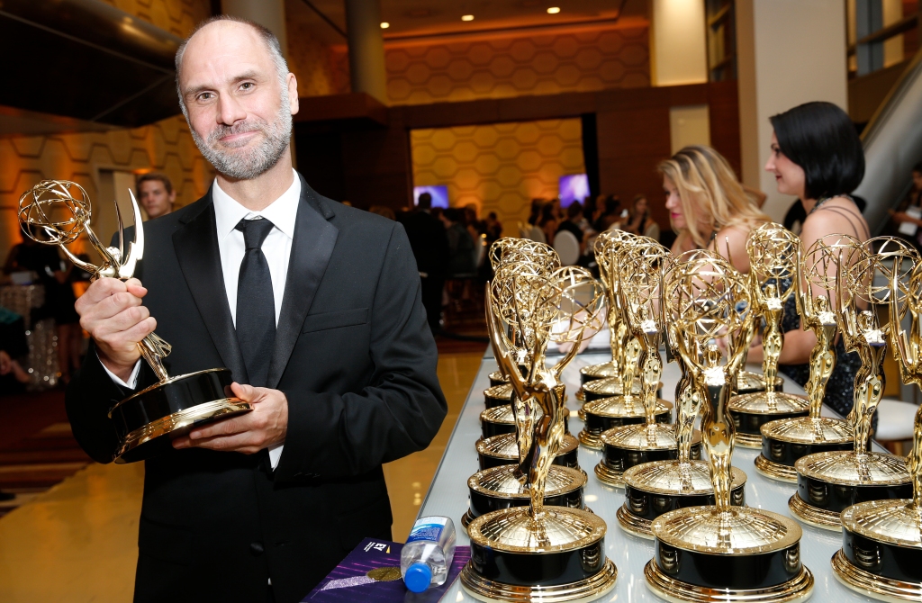Jesse Armstrong holding an Emmy. 