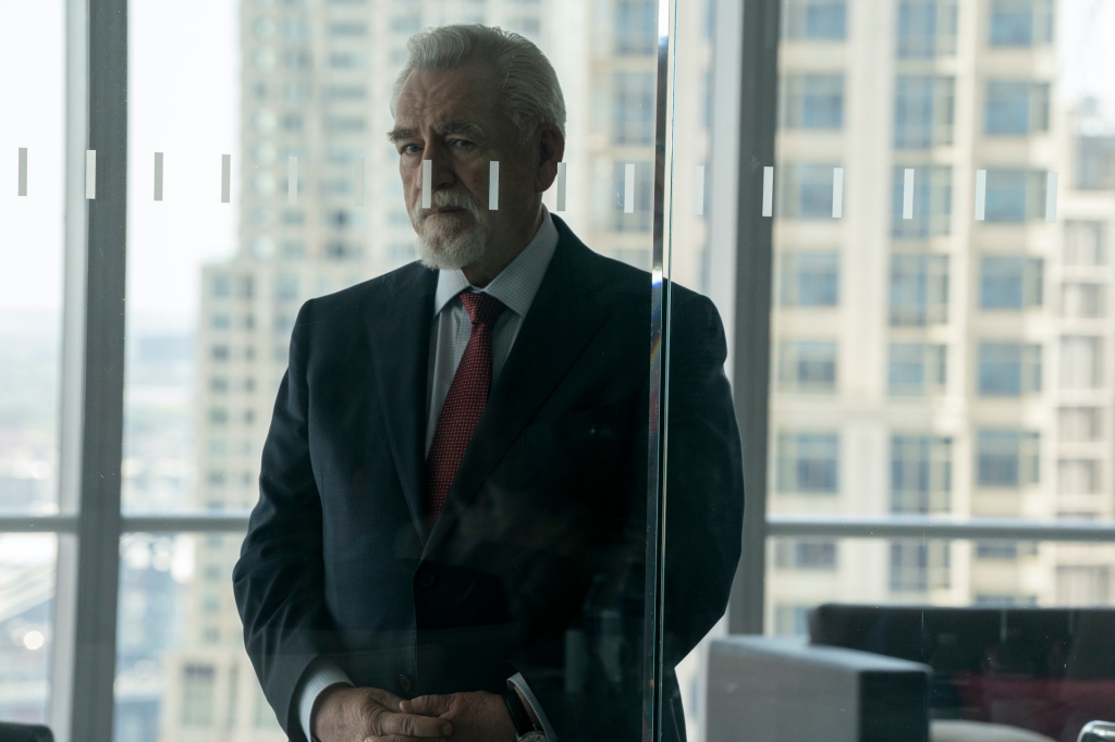 Brian Cox as Logan Roy in "Succession" standing outside a glass door. 