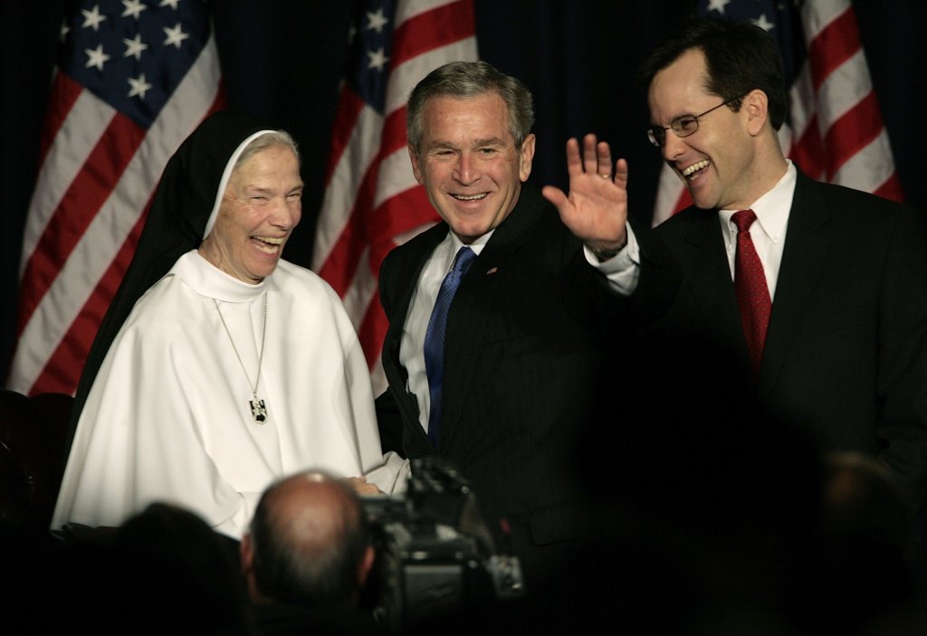 (L-R) Mother Assumpta Long , Foundress and Prioress Genereal of Sisters of Mary Mother of The Eucharist; U.S. President George W. Bush; and National Catholic Breakfast President Joseph Cella share a laugh before Bush departs the breakfast after making remarks at the Washington Hilton April 7, 2006 in Washington, DC. The president spoke about his support of federal and state initiatives to limit abortion. He said, "the Catholic Church rejects such a pessimistic view of human nature and offers a vision of human freedom and dignity rooted in the same self-evident truths of America's founding."
