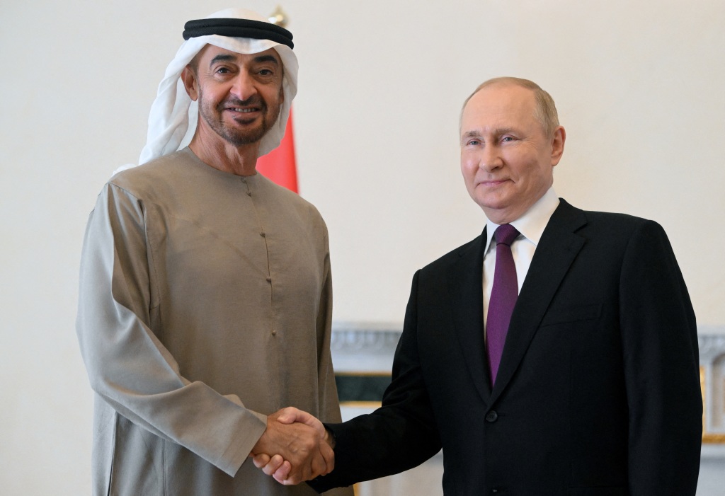 Russia's President Vladimir Putin shakes hands with United Arab Emirates' President Sheikh Mohammed bin Zayed al-Nahyan.