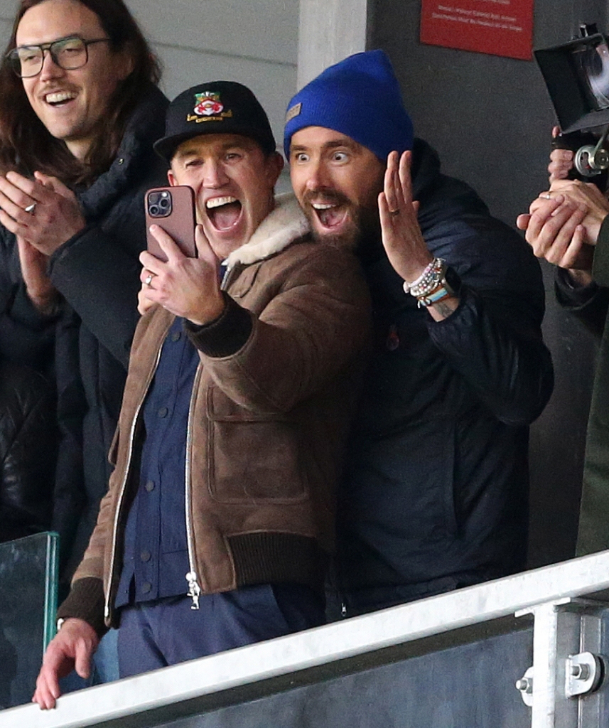 McElhenney and Reynolds enthusiastically taking photo in stands