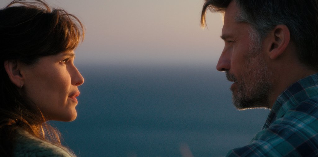 Hannah (Jennifer Garner) and her missing husband, Owen (Nikolaj Coster-Waldau) stand outside looking at each other, expressions serious, faces in profile. 