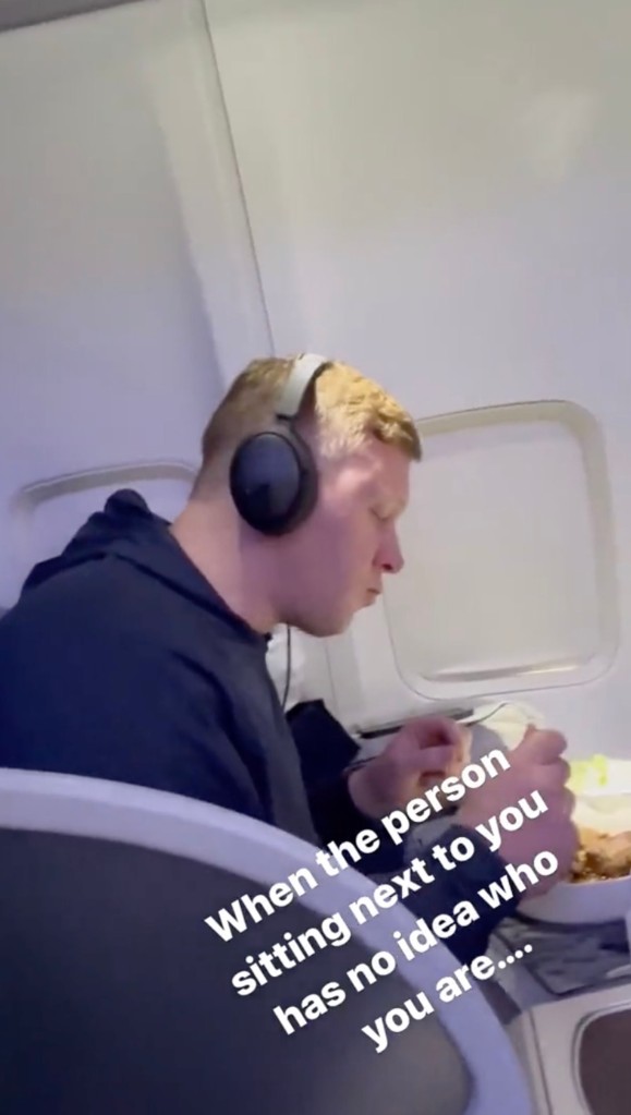 Delta passenger eating and watching "The Office"