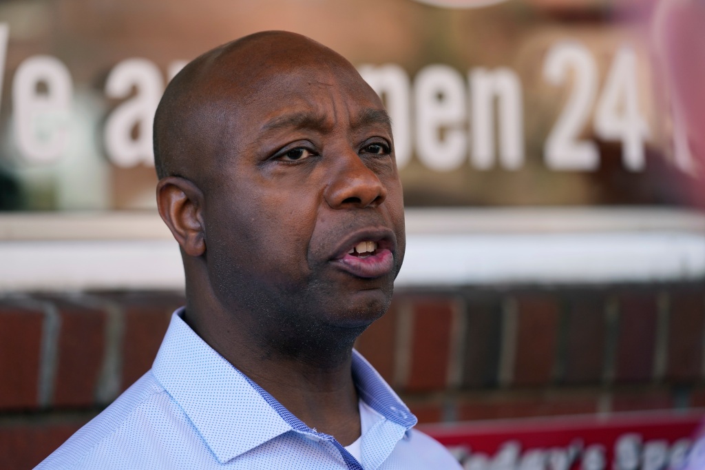 Sen. Tim Scott, R-S.C., talks with reporters during a visit to the Red Arrow Diner, 