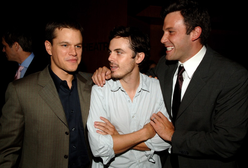 Matt Damon, Casey Affleck and Ben Affleck standing together, smiling. 