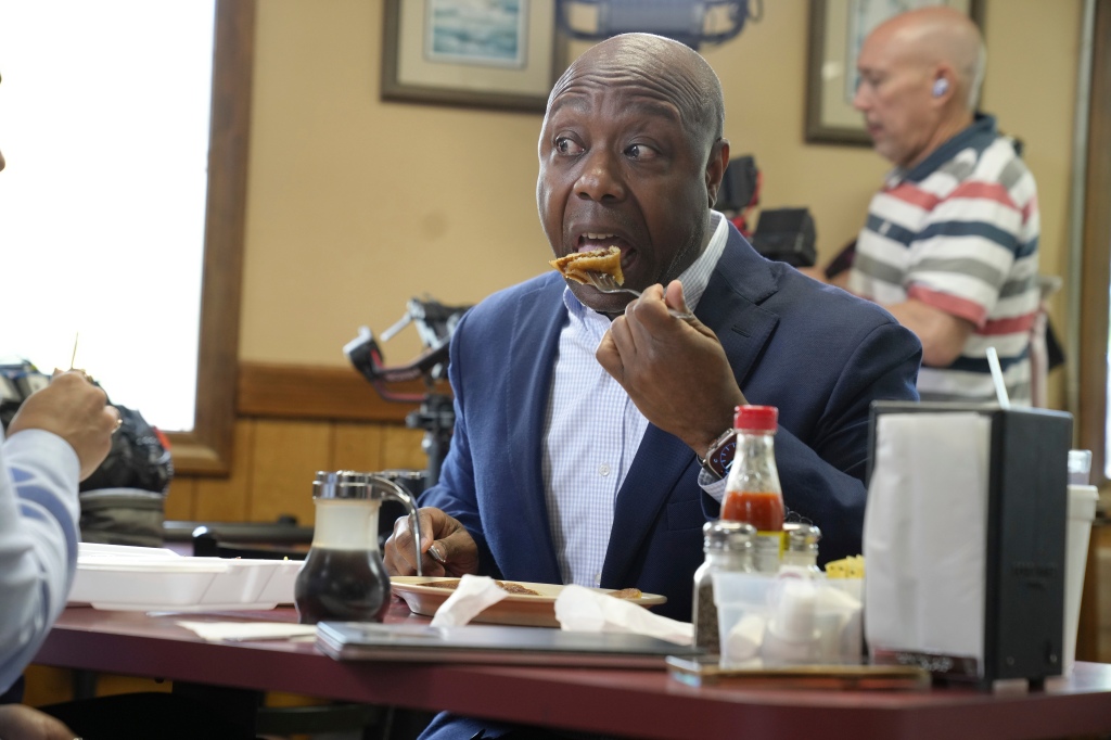 Sen. Tim Scott, R-S.C., takes a bite of pancakes after a media interview following his meet and greet with diners at Alex's Restaurant on Friday, April 14,