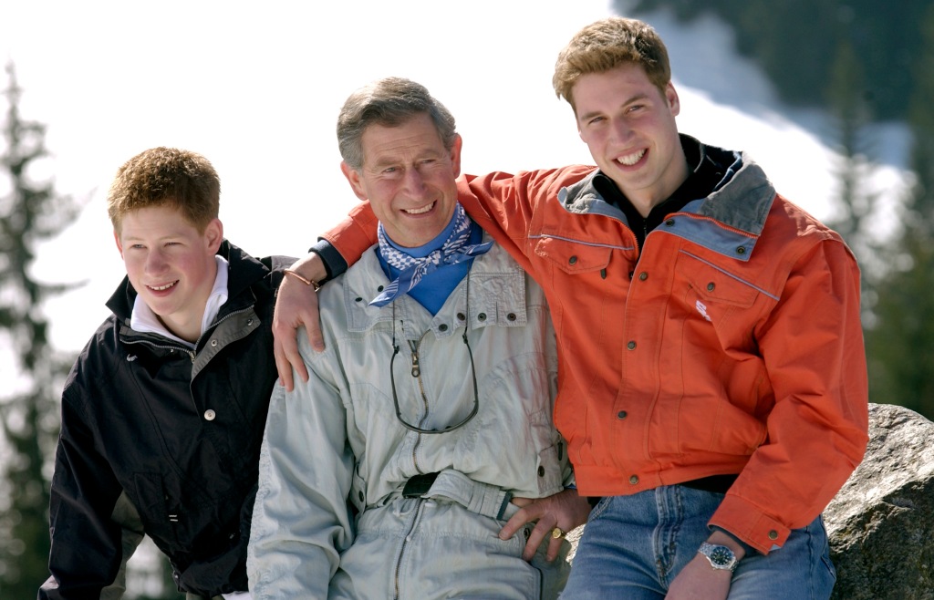 Prince Charles smiles with his teenage sons, Prince William and Prince Harry, at the start of their annual skiing holidays, in 2002.