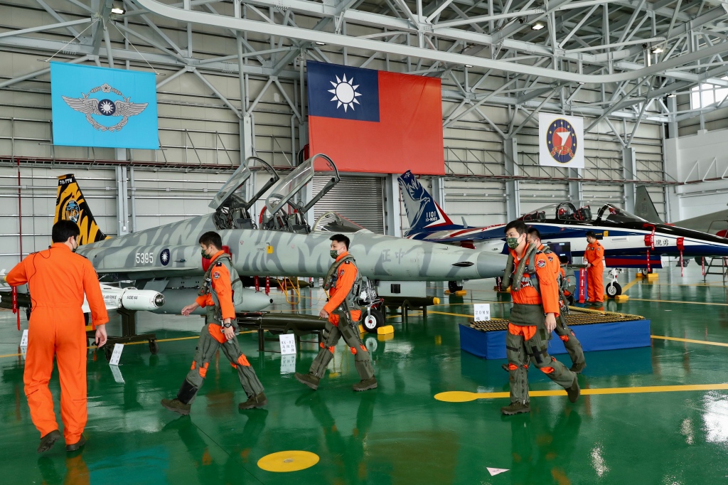 Taiwanese pilots of F-5 fighter jets walk in a hangar ahead of the visit of Taiwan.