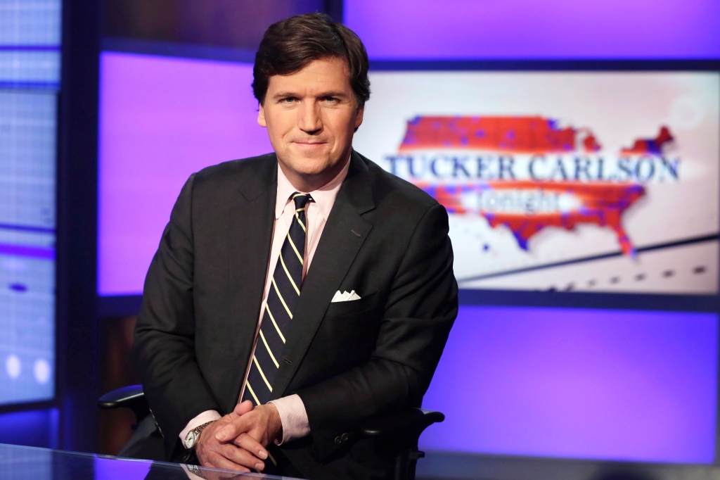 Tucker Carlson, host of "Tucker Carlson Tonight," poses for photos in a Fox News Channel studio.