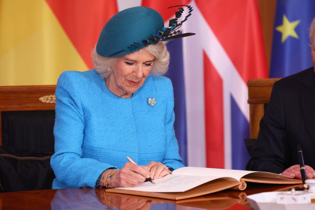 Camilla - Queen Consort signs the official guest book at Schloss Bellevue presidential palace on the first day of the state visit to Germany on March 29, 2023 in Berlin, Germany