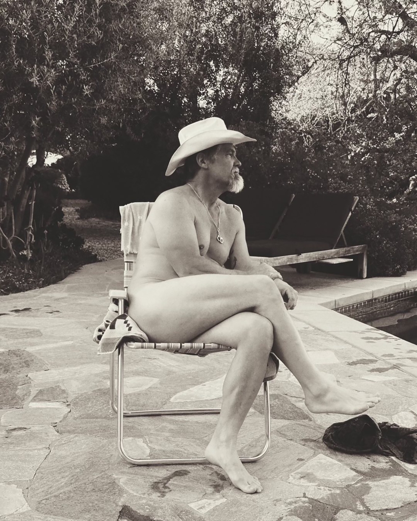 Josh Brolin sitting in a chair, nude. 