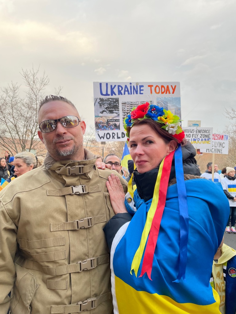 James Vasquez posing with then-wife Tina wrapped in Ukraine flag.