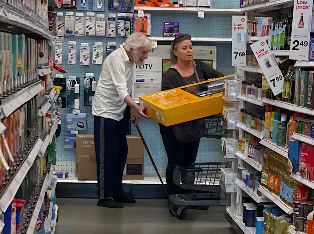 The happy couple was spotted browsing the store's vast selection of televisions before selecting a Vizio model which Van Dyke, 97, gladly helped steady as his wife pushed the cart. 
