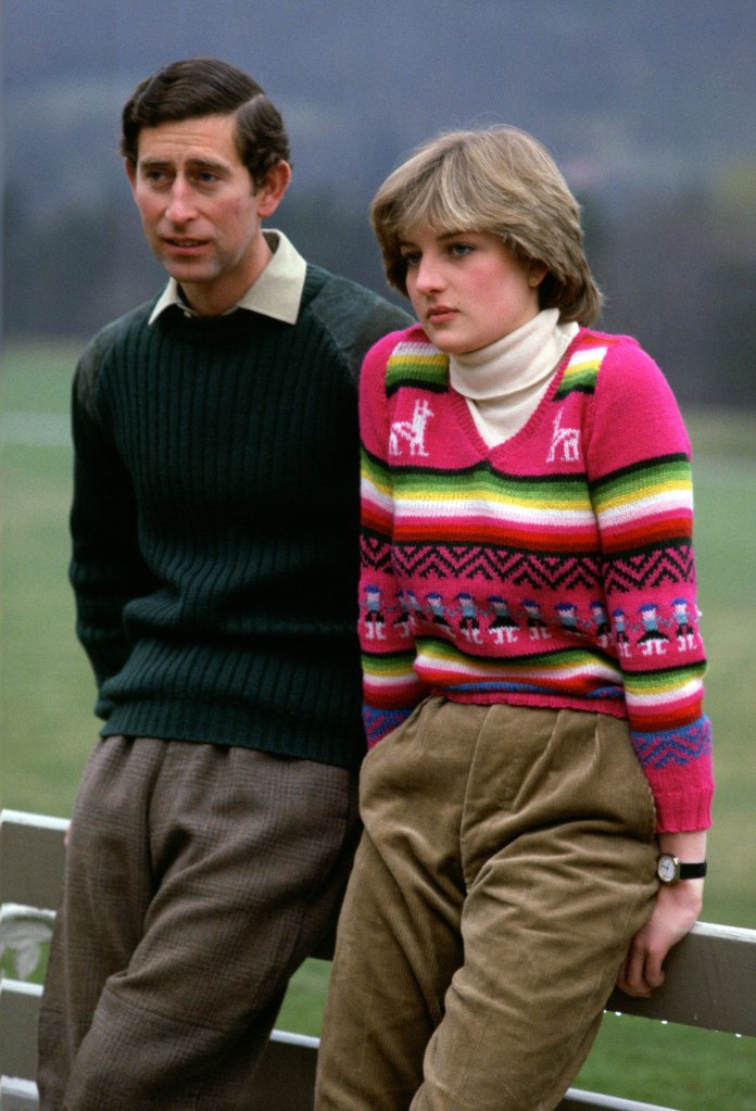 Prince Charles and Lady Diana Spencer during a photo shoot before their wedding, leaning on a fence. 