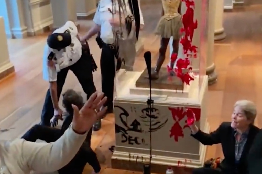 Onlookers were stunned by the moment when the protesters started vandalizing the sculpture. 