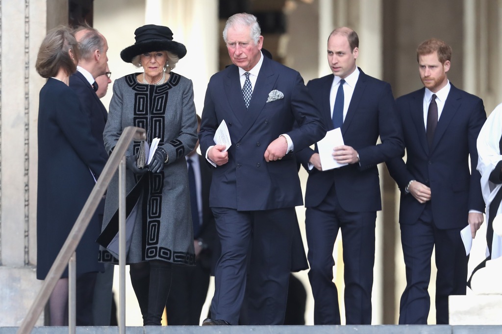 Camilla, Duchess of Cornwall, Prince Charles, Prince of Wales, Prince William, Duke of Cambridge and Prince Harry in 2017, walking in a line on the sidewalk looking serious. 
