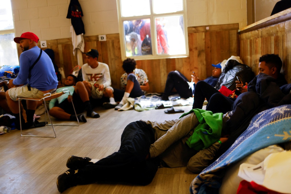 Migrants resting at the Opportunity Center for the Homeless shelter in El Paso. 