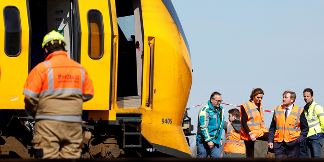 King Willem-Alexander of the Netherlands, bottom right, is seen inspecting the crash site.