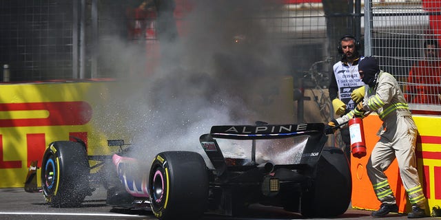 Track marshals put out the fire in the car of Pierre Gasly 