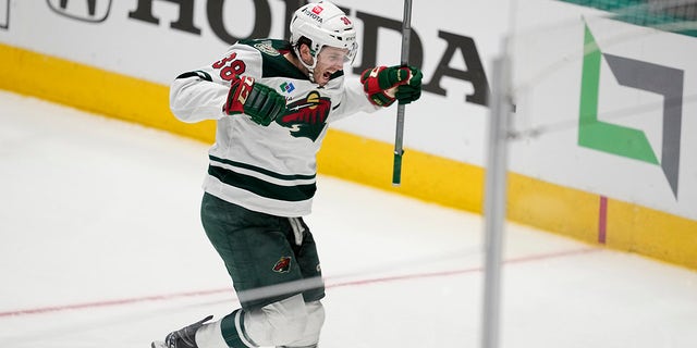 Minnesota Wild right wing Ryan Hartman (38) celebrates after scoring in the second overtime of Game 1 of an NHL hockey Stanley Cup first-round playoff series against the Dallas Stars, Tuesday, April 18, 2023, in Dallas. 