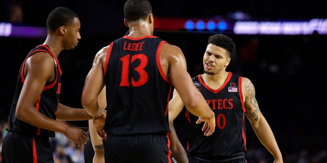 Matt Bradley #20 of the San Diego State Aztecs reacts with teammates during the second half against the Connecticut Huskies during the NCAA Men's Basketball Tournament National Championship game at NRG Stadium on April 03, 2023 in Houston, Texas.