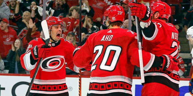 Carolina Hurricanes' Seth Jarvis, left, celebrates after a goal with Stefan Noesen, right, and Sebastian Aho (20) during the second period of Game 1 of an NHL hockey Stanley Cup first-round playoff series in Raleigh, N.C., Monday, April 17, 2023. 