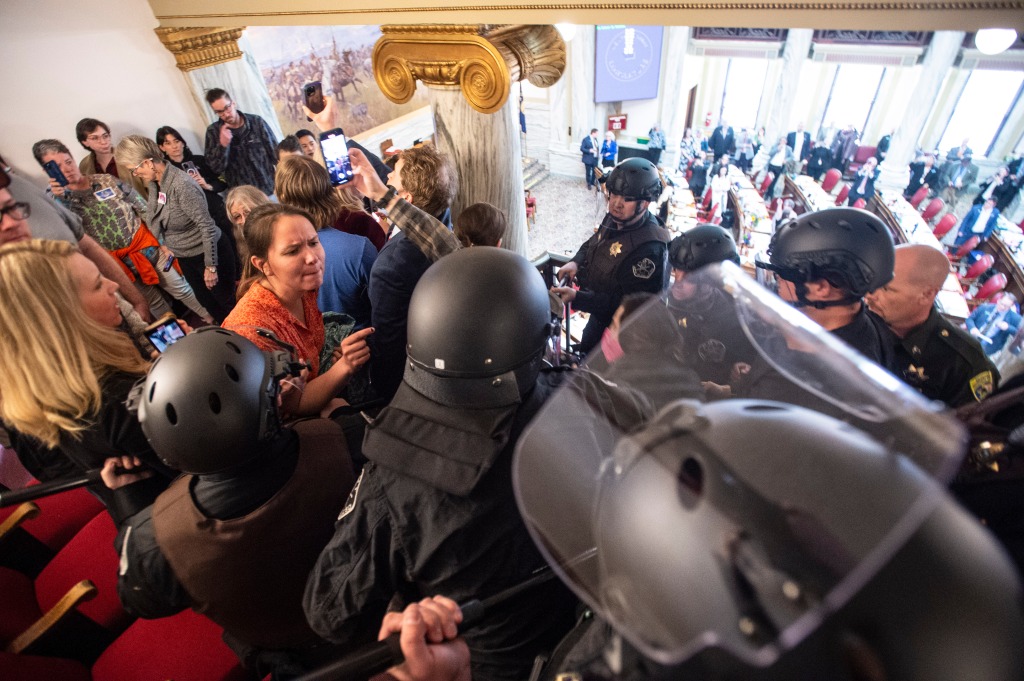 Law enforcement forcibly clear the Montana House of Representatives gallery during the protest on April 24, 2023, in Helena, Mont.