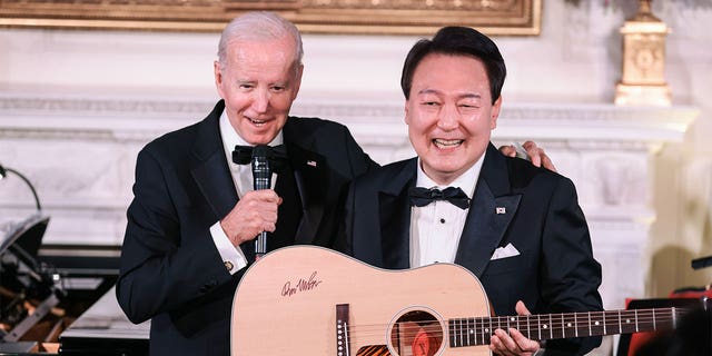 Yoon Suk Yeol, South Korea's president, holds a guitar 