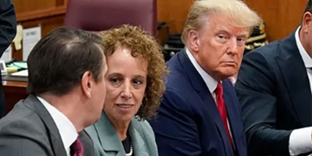 Former U.S. President Donald Trump sits at the defense table with his defense team in a Manhattan court during his arraignment on April 4, 2023, in New York City. 