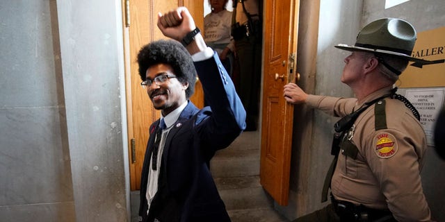 FILE: Rep. Justin Pearson, D-Memphis, raises his fist after visiting with supporters in the gallery of the House chamber Thursday, April 6, 2023, in Nashville, Tenn.