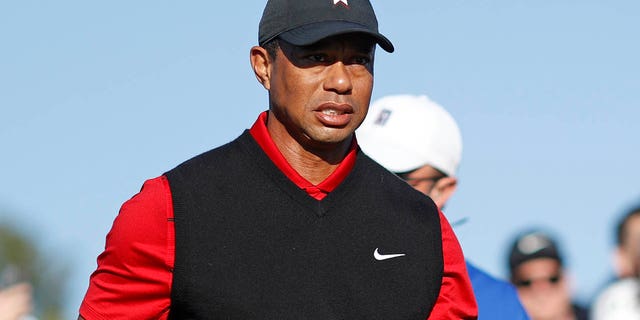 Tiger Woods of the United States looks on after he plays his second shot on the first hole during the final round of the The Genesis Invitational at Riviera Country Club on February 19, 2023 in Pacific Palisades, California.